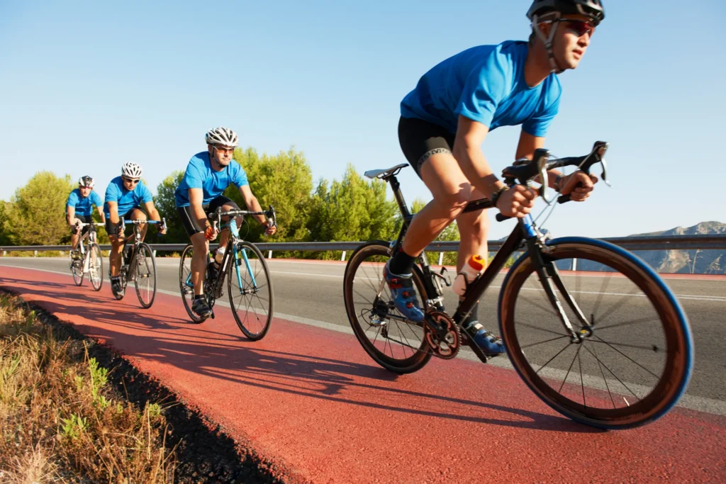cyclists riding bicycles on red lane