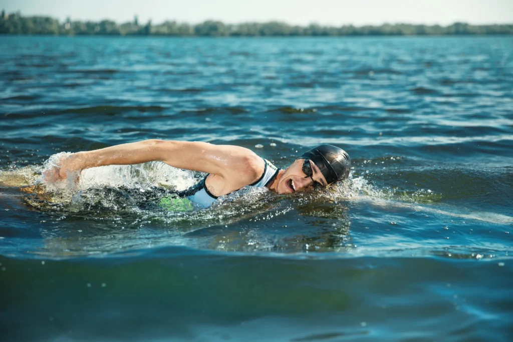 male swimmer crawling through open water