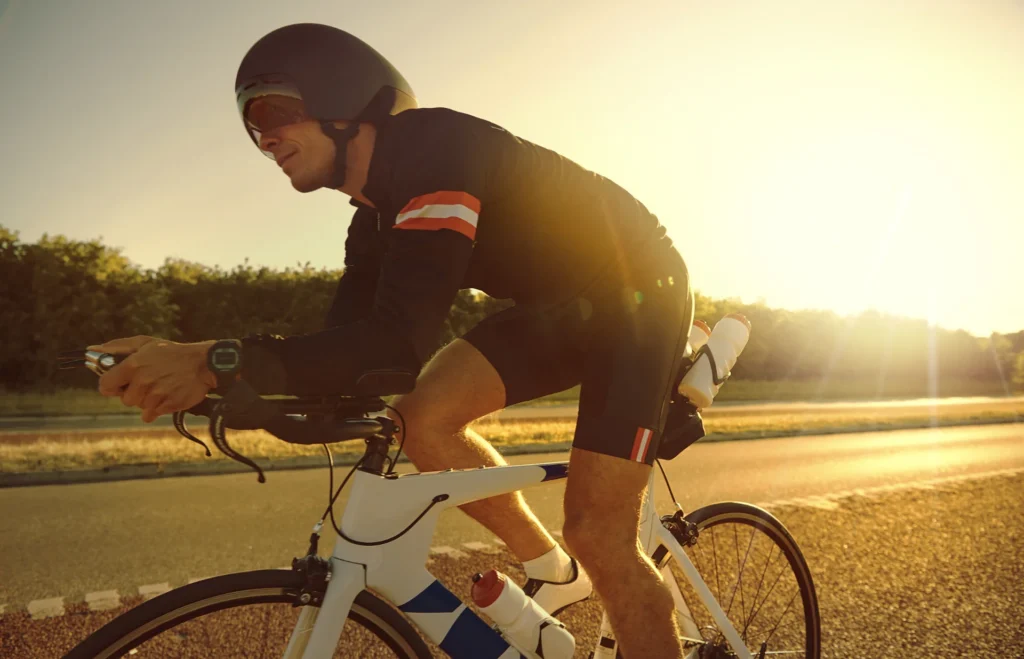 man cycling on road during golden