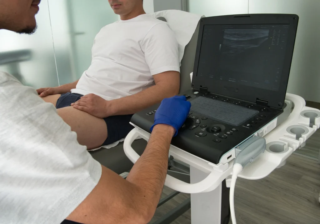 man receiving ultrasound examination in hospital