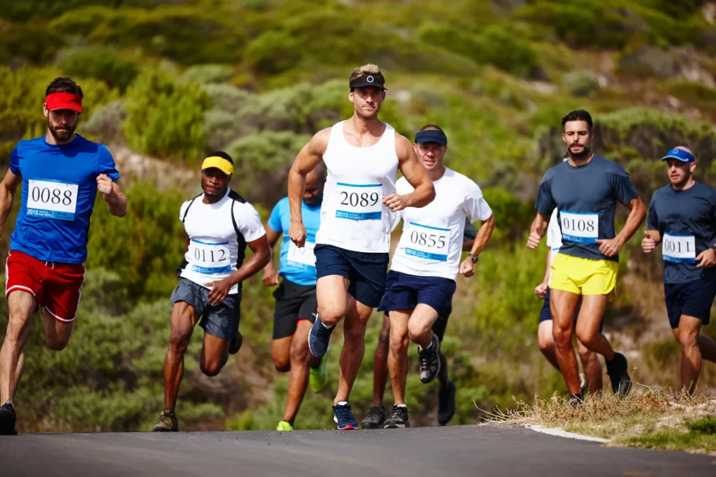 men run marathon along paved road