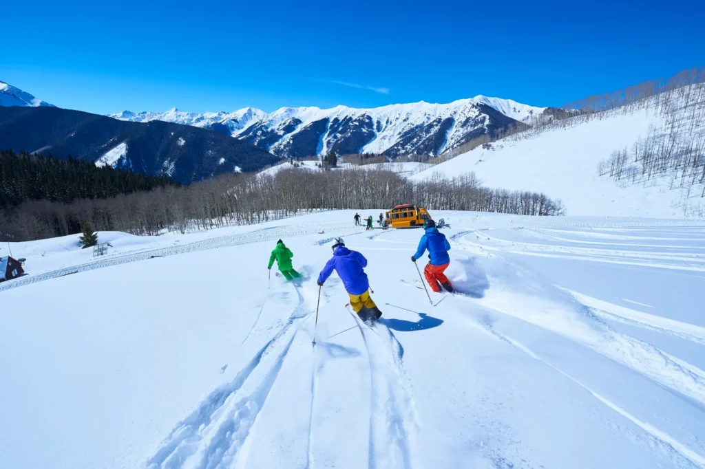 rear view of men skiing down snow covered ski