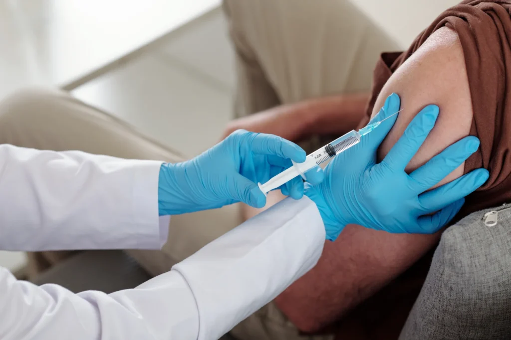 vaccination arm injection by doctor in healthcare