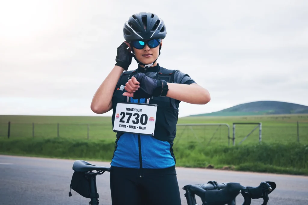 woman cyclist checks time during