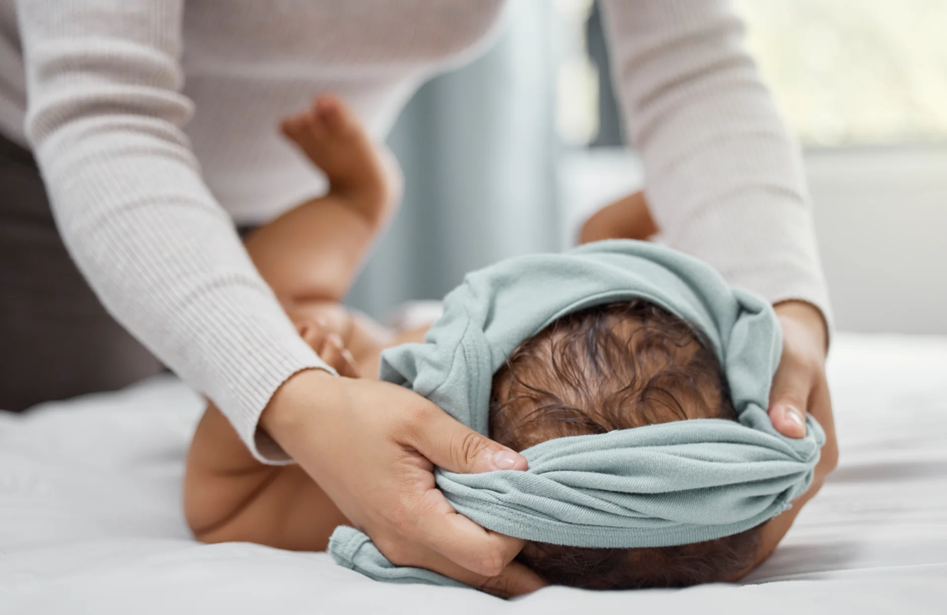 caring parent and infant at home